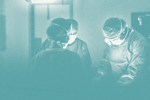 Several surgeons around a patient; illustrative of breast cancer surgery